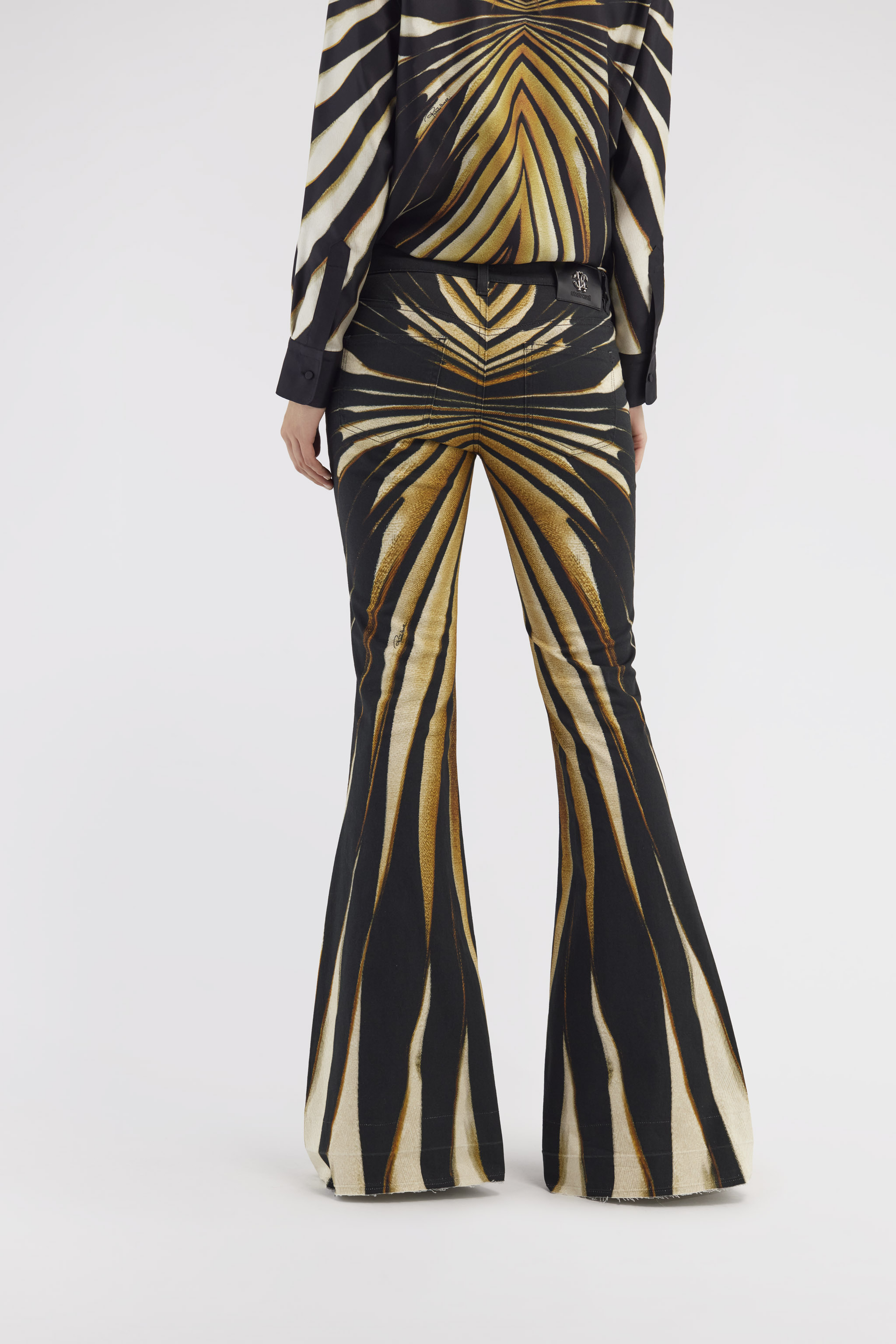 Flared jeans with Ray of Gold print